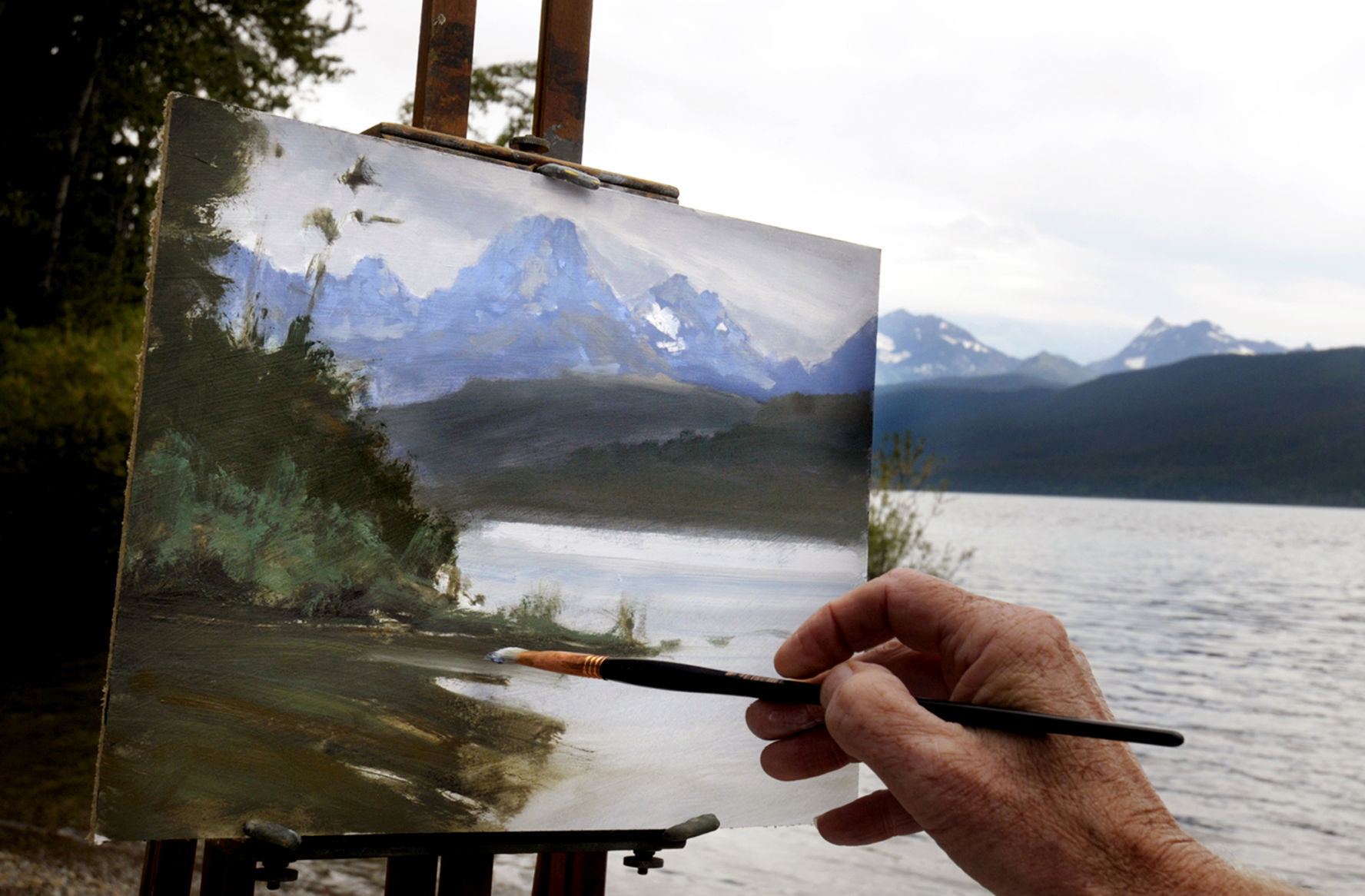 Artist Mark Ogle paints Lake McDonald